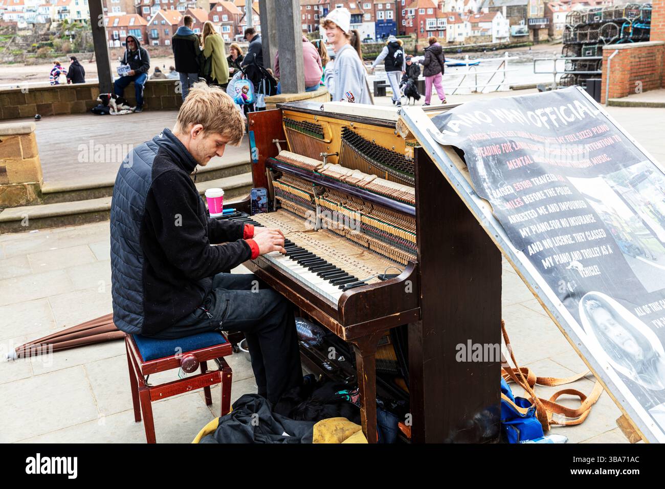 Pianist, piano player, playing piano, playing piano outside, pianoist, musician, player, piano, piano playing, Whitby, Yorkshire, UK, England Stock Photo