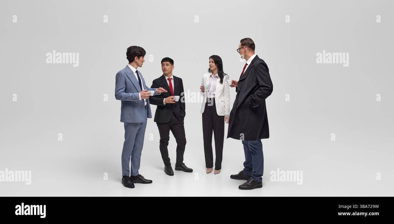 Signifying Studio Two individuals shake hands during business meeting against white ...