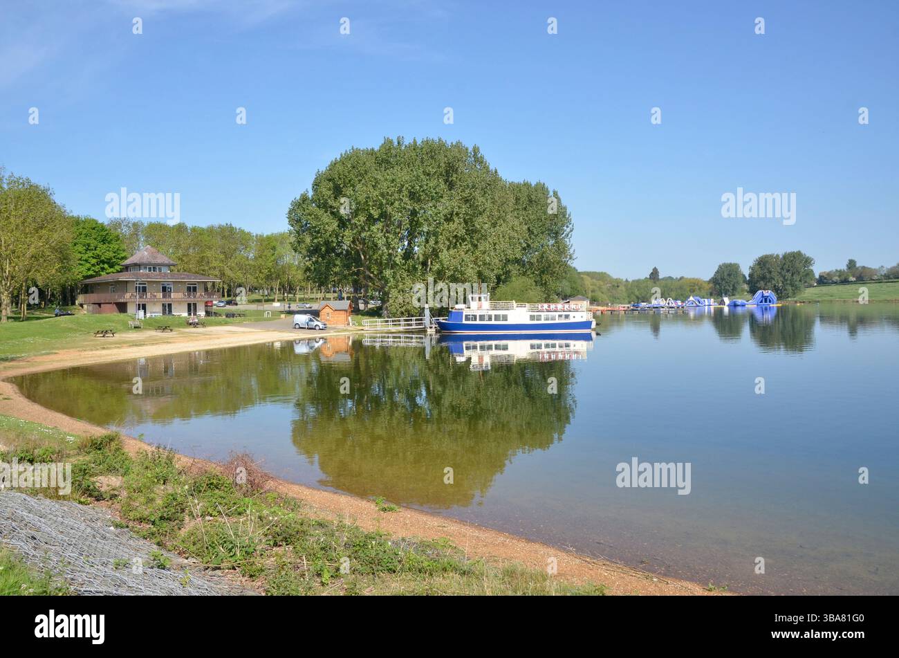The Rutland Belle, a water cruise boat on Rutland Water, plying between Whitwell and Normanton. The Whitwell Aqua Park is visible to the right. Stock Photo
