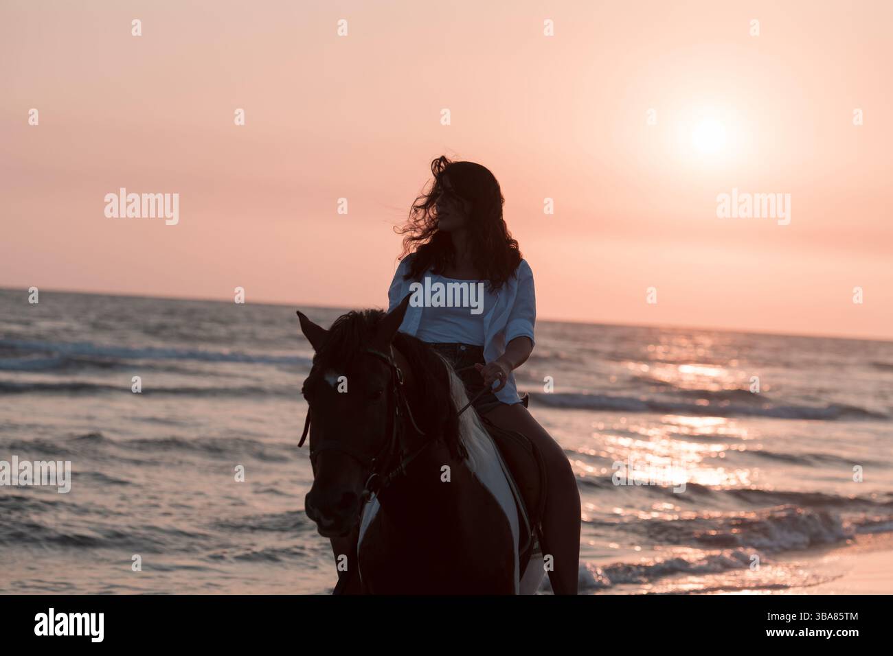 Mixed Riding Mixed race woman wearing white top and short jeans looking away while ...