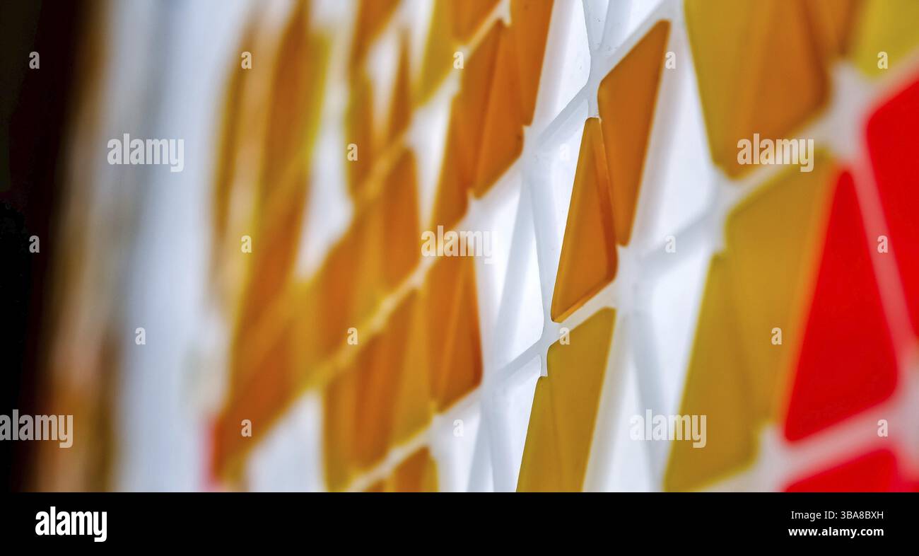 Puzzle made of colored glass with triangular shapes Stock Photo