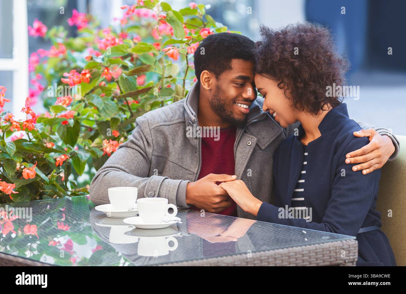 Lovely date. Sweet african american couple holding each other hands in ...