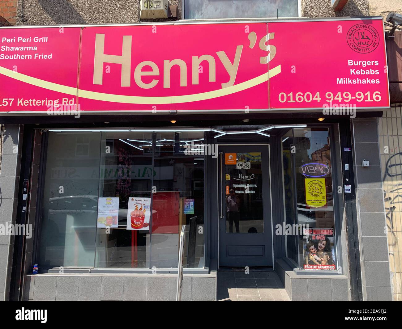 Henny's food shop restaurant Northampton UK England Kettering Road eat eating in takeaway place type restaurant sign signs door glass window outside - Smartphone Captured Stock Image