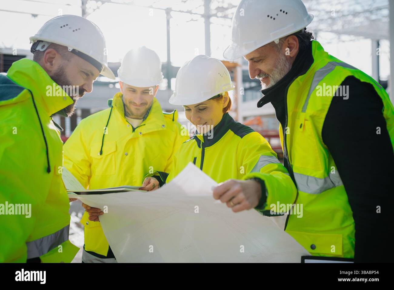 Team of engineers and construction workers inspecting building progress ...