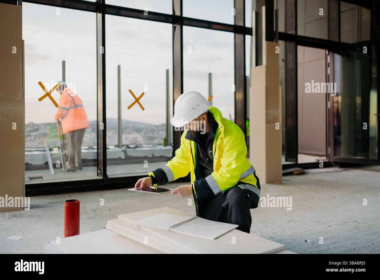 Construction site manager using digital tablet to inspect building progress. Stock Photo
