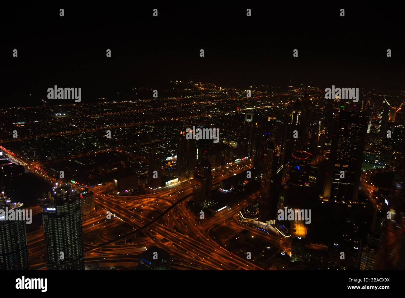 Aerial view of a vibrant city skyline at night, showcasing illuminated ...