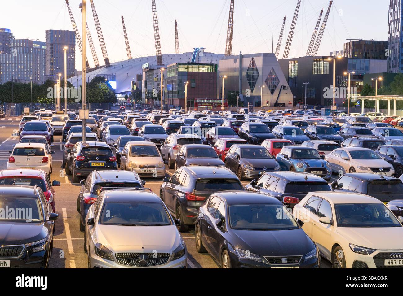Visitors to the North Greenwich Peninsula in London to enjoy its nightlife, with hundreds of cars left in the nearby short-stay car park , UK Stock Photo
