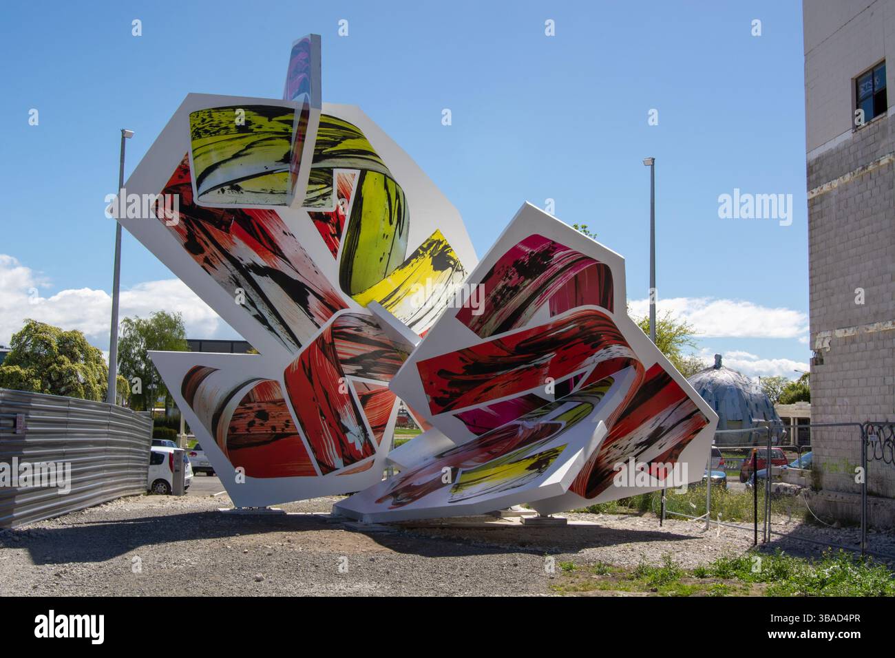 A large, abstract sculpture featuring vibrant colors and dynamic shapes ...