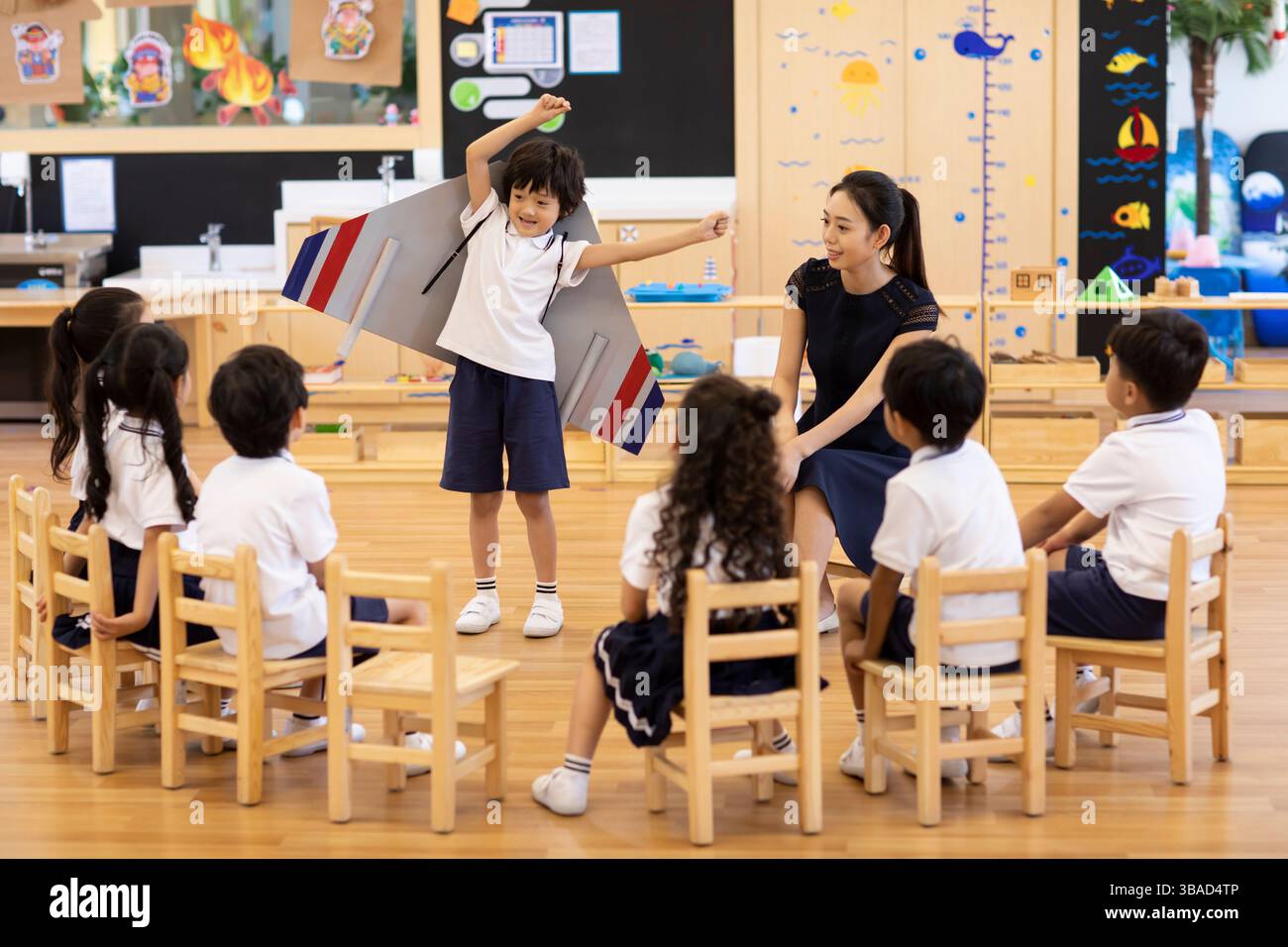 Chinese female teacher and children having art class in classroom Stock ...