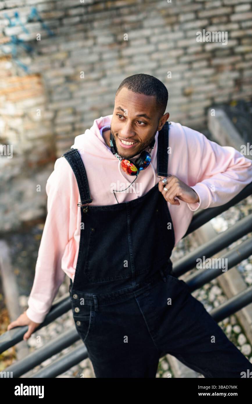 Young black man wearing casual clothes smiling on urban stairs. Happy ...