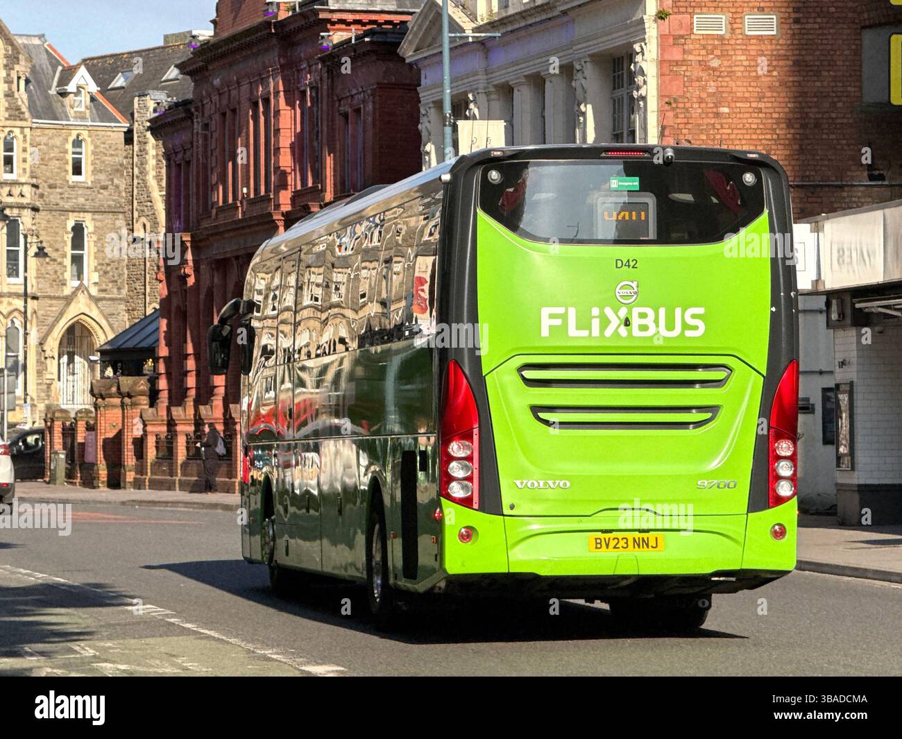 Carsiff, Wales, UK - 9 May 2025: Express coach operated by budget travel bus company Flixbus driving on a street in Cardiff city centre - Smartphone Captured Stock Image