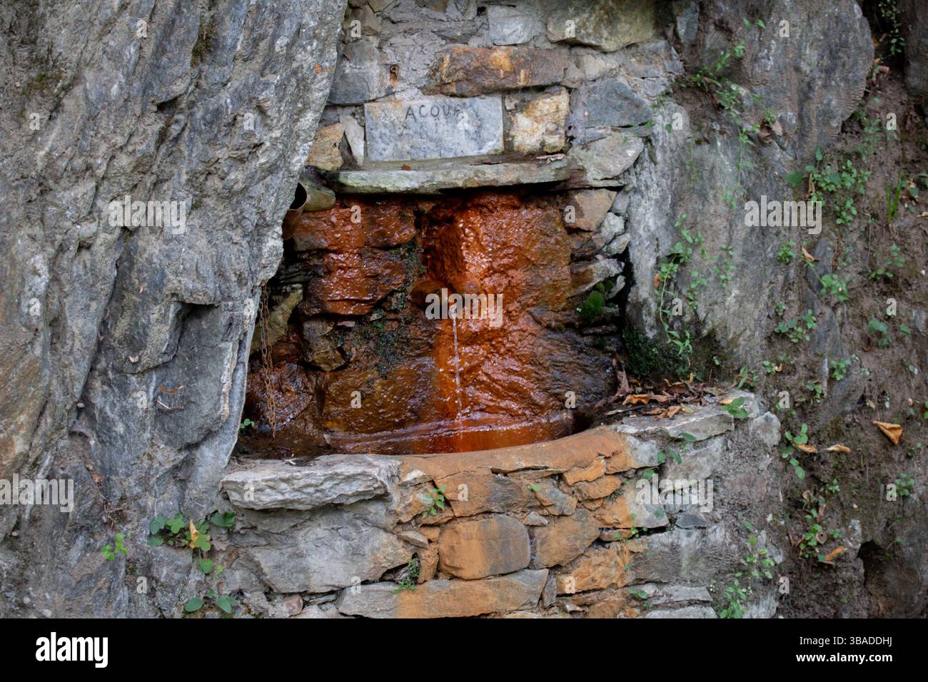 Rustic Stone Spring With Natural Water Flowing From a Rock Formation Stock Photo
