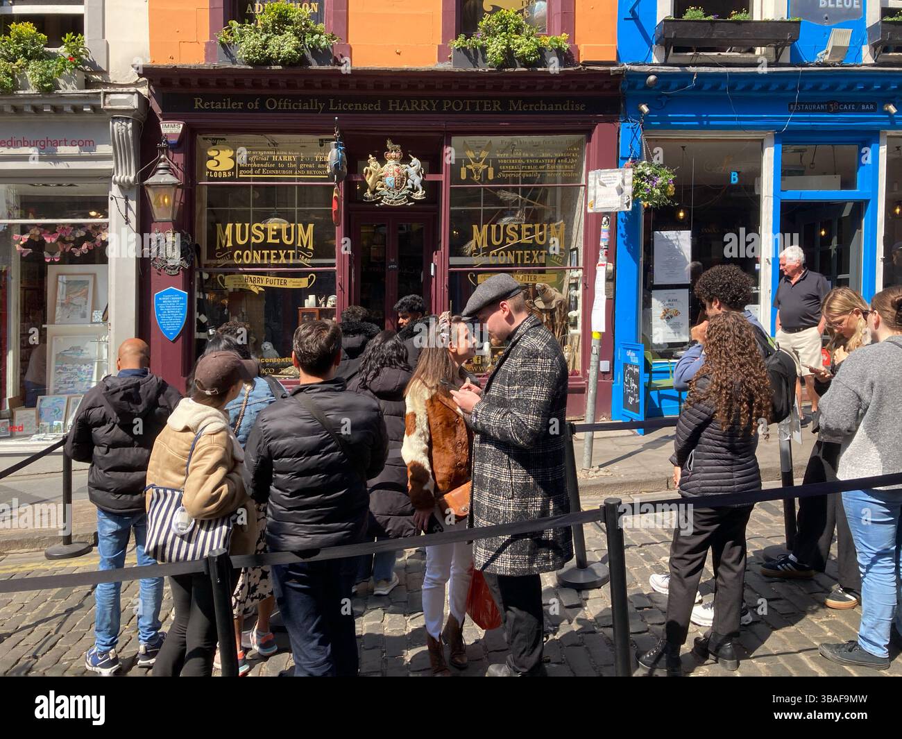Queues awaiting entry outside the Harry Potter Museum, Victoria Street Edinburgh, Scotland - Smartphone Captured Stock Image