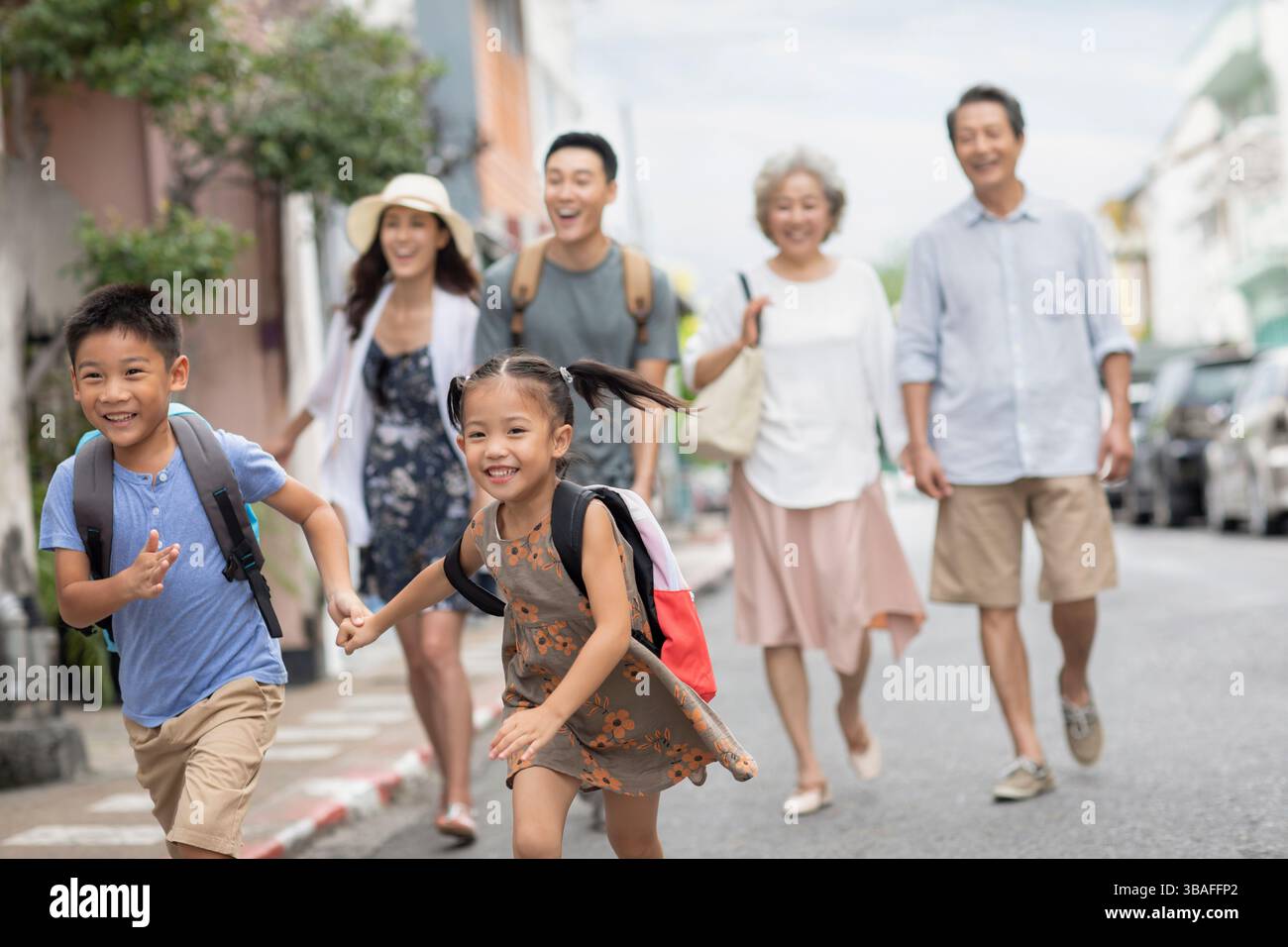 Chinese family walking on city street during daytime Stock Photo - Alamy