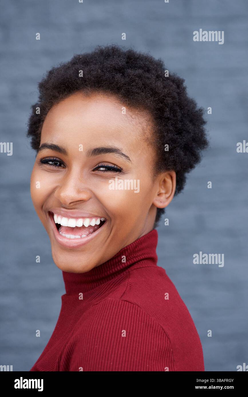 Close up side portrait of beautiful young black woman laughing Stock ...
