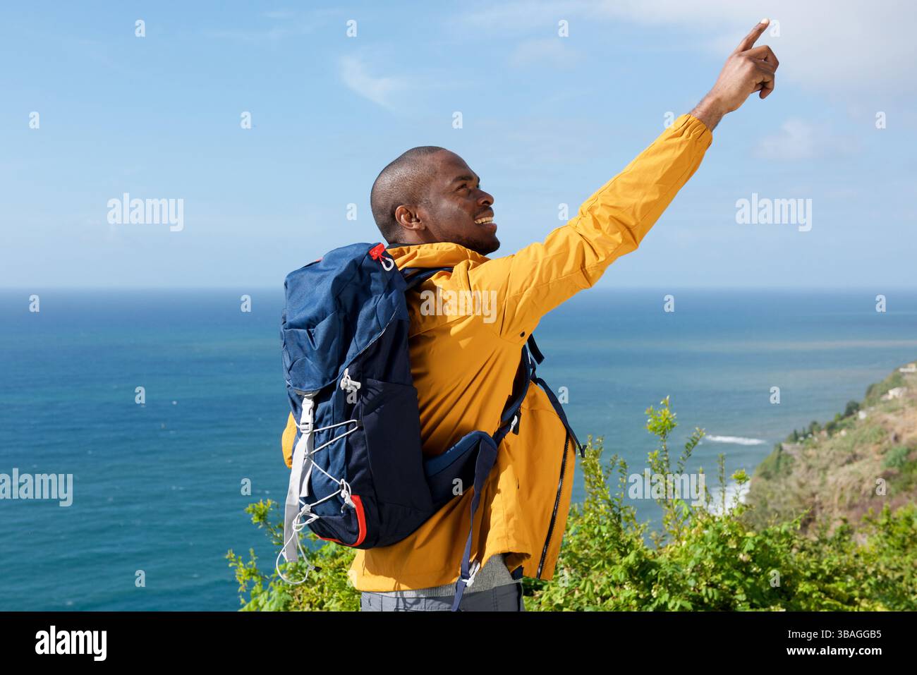 Portrait of young black man hiking and pointing finger Stock Photo - Alamy