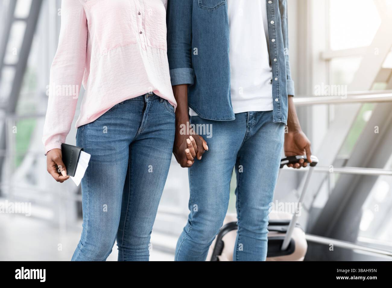 Unrecognizable black travellers couple walking in airport terminal ...
