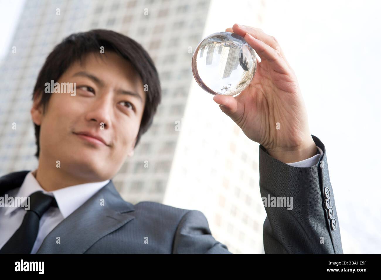 Chinese businessman holding crystal ball Stock Photo - Alamy