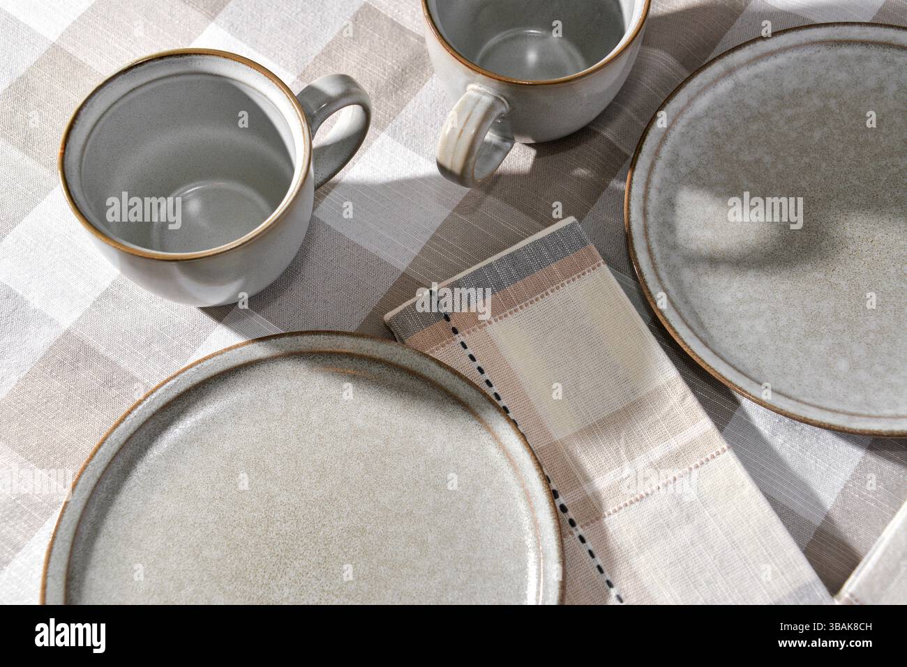 Empty plates and coffee cups on table Stock Photo