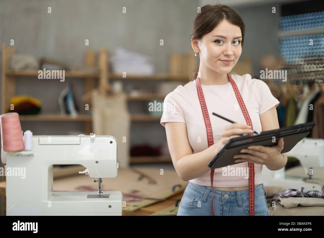 Woman dressmaker makes pattern using tablet Stock Photo