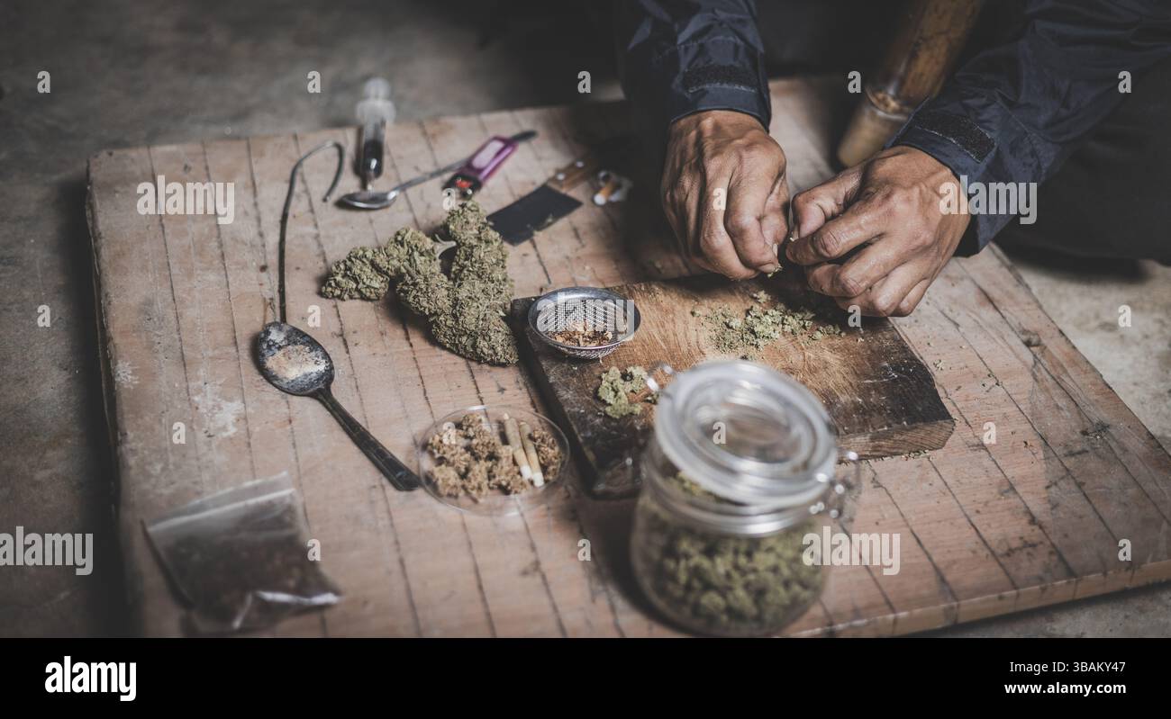 A person man sits alone in a dark room smoking marijuana, Drug addict ...
