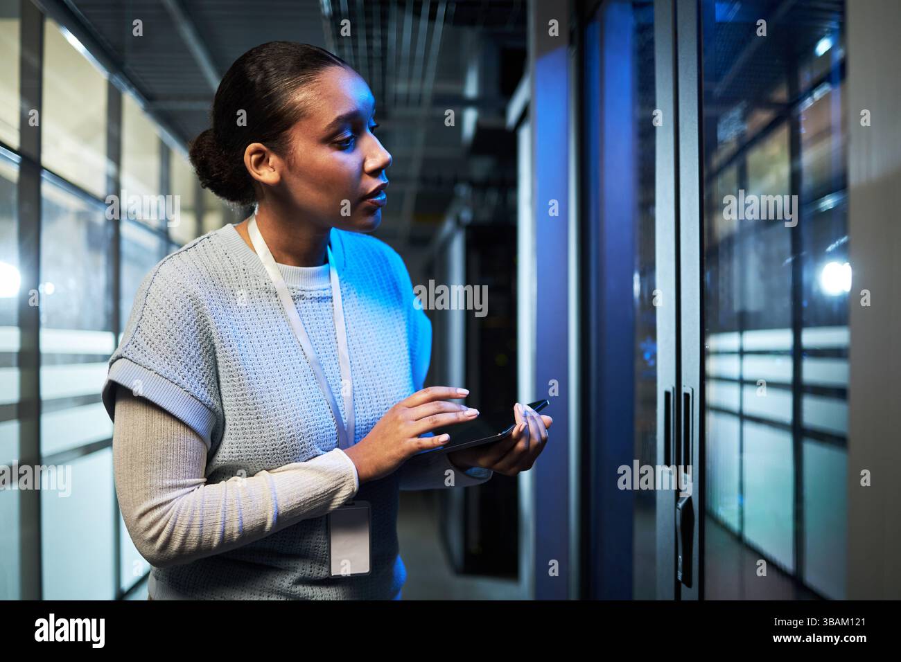 Inspecting Data Center Server Room with Tablet Device Stock Photo