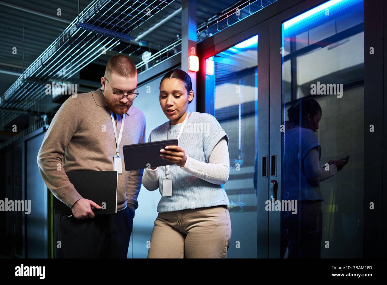 Discussing Data Security Strategies in Server Room Stock Photo