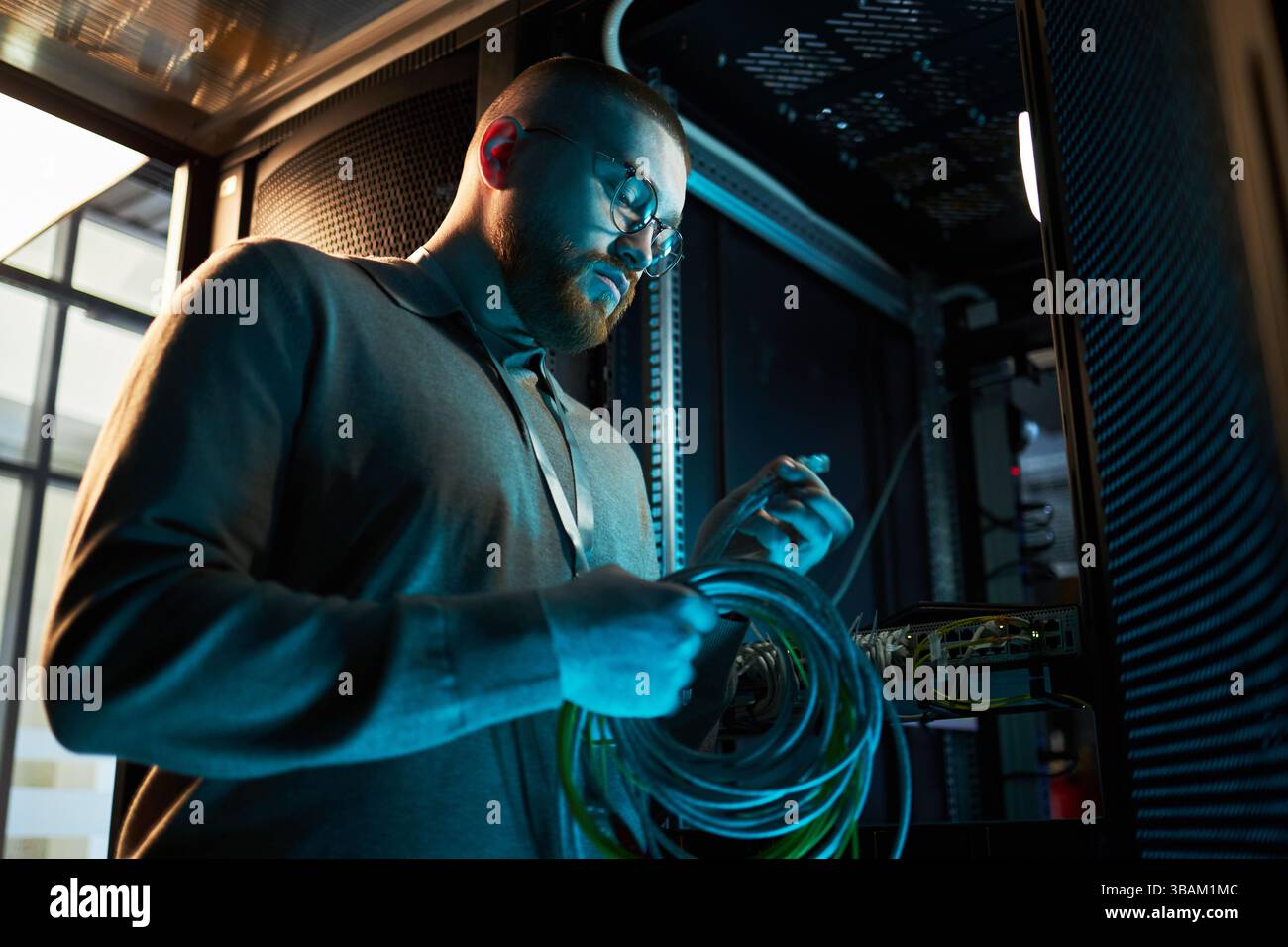 Technician Working Inside Network Server Room Stock Photo