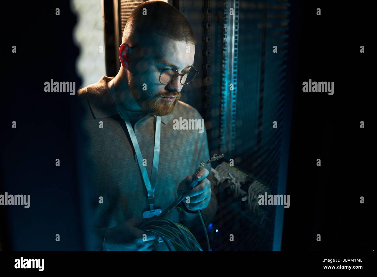 At Work Maintaining Network Cables in Data Center Stock Photo