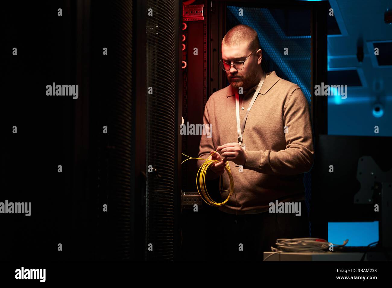 Technician Working Inside Data Center With Network Cables Stock Photo