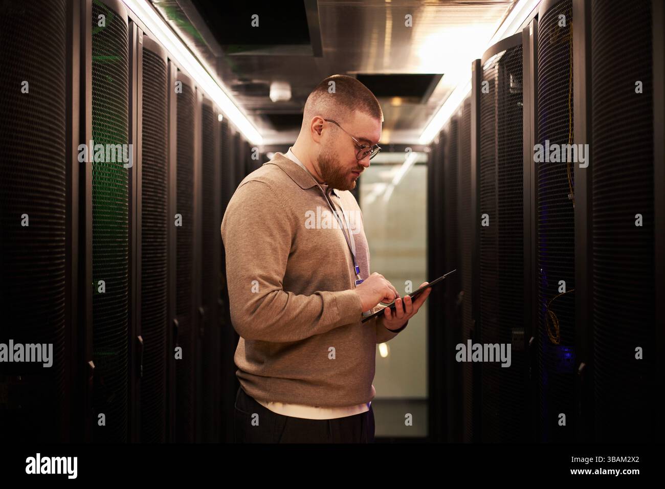 Man Wearing Glasses Working in Data Center Stock Photo