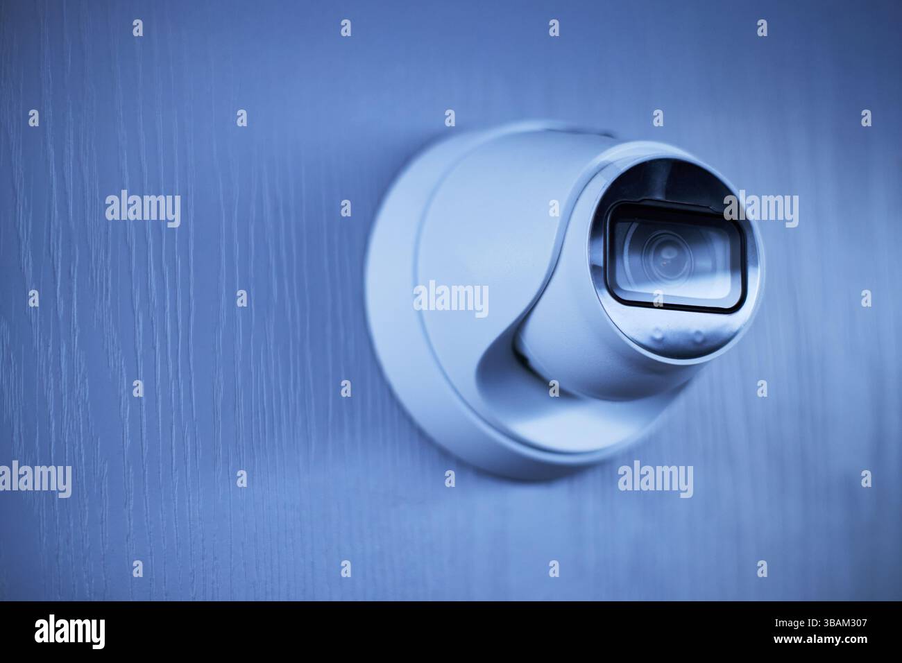 Modern Surveillance Camera Affixed on Wall Stock Photo