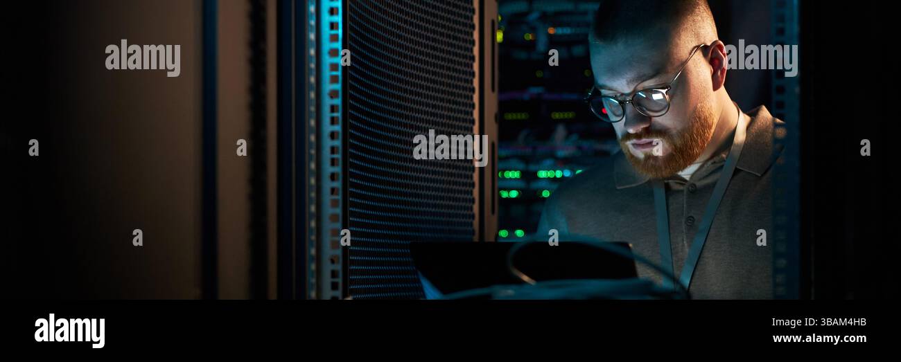 IT Technician Working in Data Server Room Stock Photo