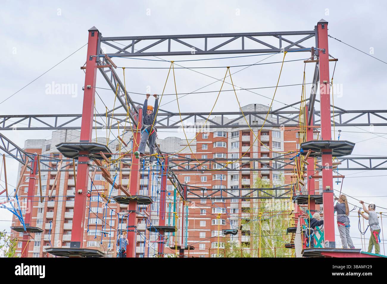 Yekaterinburg, Russia: May 9, 2025: Kids navigating high rope obstacles ...