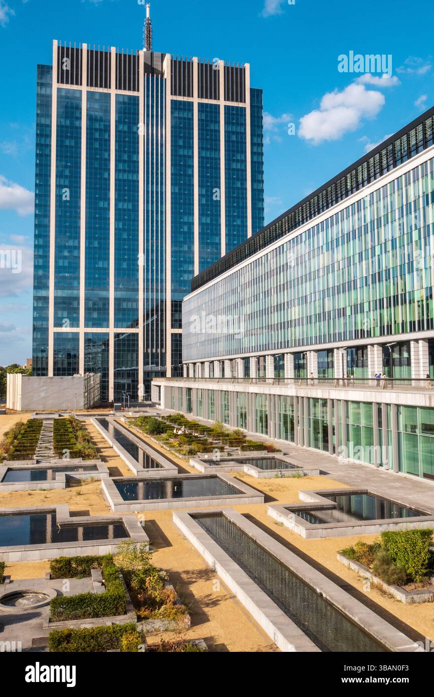 Vertical view of modern glass buildings and botanical garden in ...