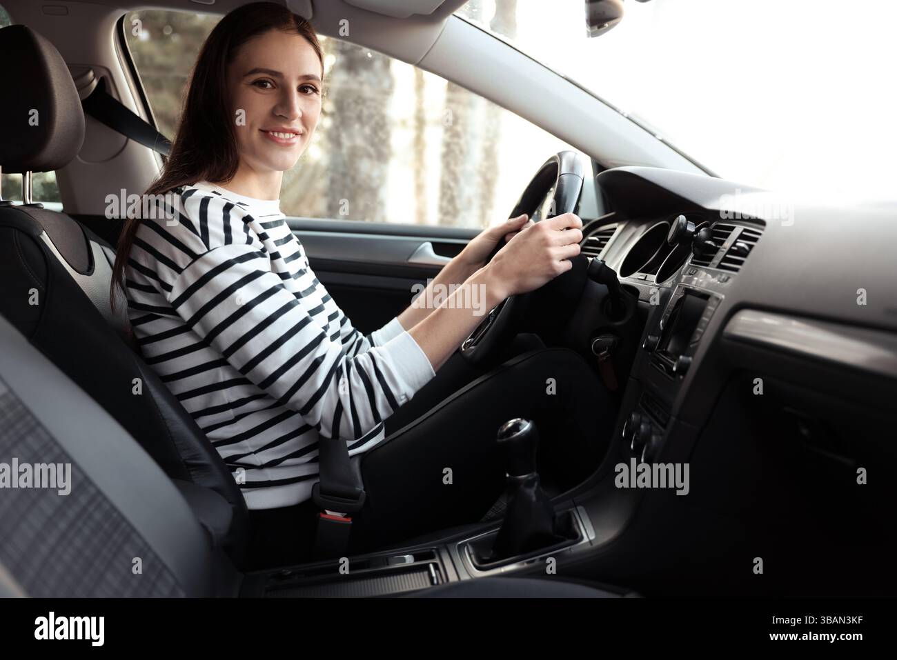Driver behind steering wheel of modern car Stock Photo - Alamy