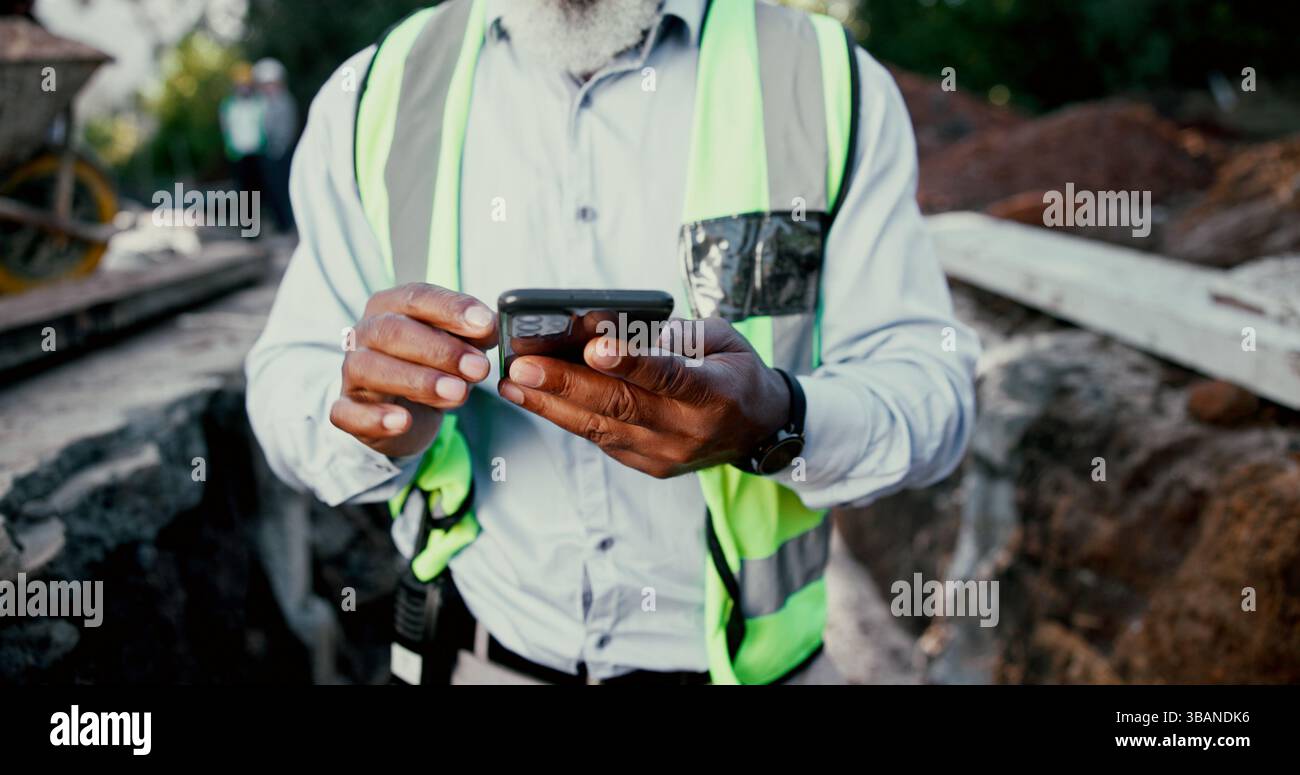 Construction site, hands and phone with person outdoor for communication, excavation or update. App, building and contact with professional developer Stock Photo