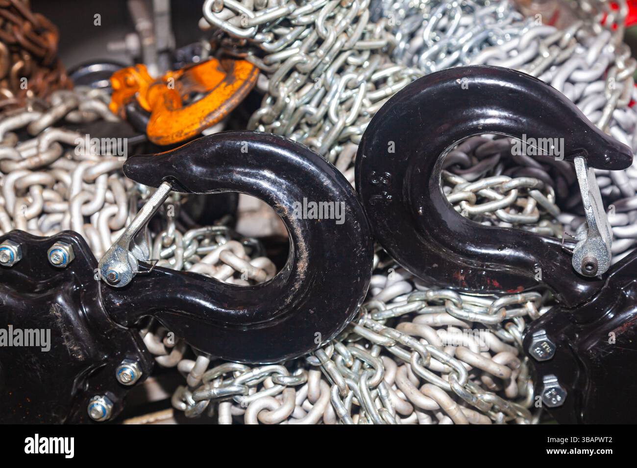 Chain hoists for lifting weights in a workshop close-up. Stock Photo