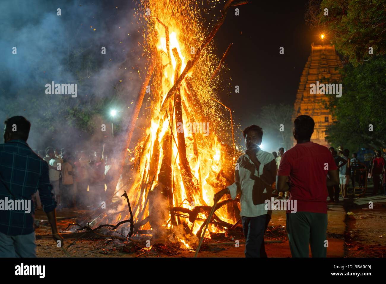 Hindu celebrating Holika Dahan, ritual bonfire on the evening before ...