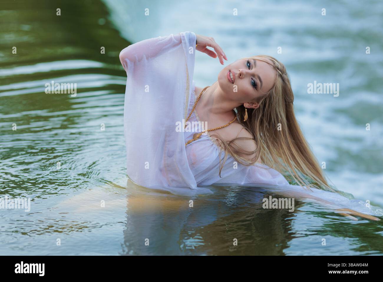 Beautiful Girl with long hair swims and dances in water Stock Photo - Alamy