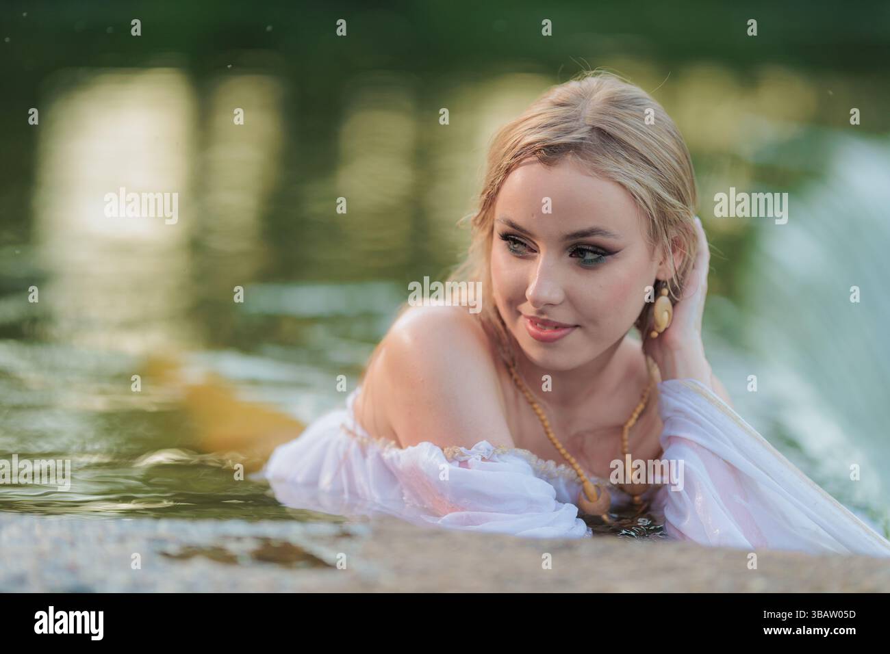 Beautiful Girl with long hair swims and dances in water Stock Photo - Alamy