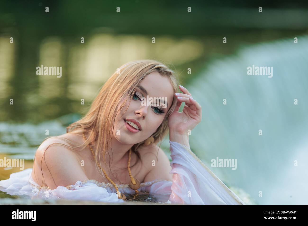 Beautiful Girl with long hair swims and dances in water Stock Photo - Alamy