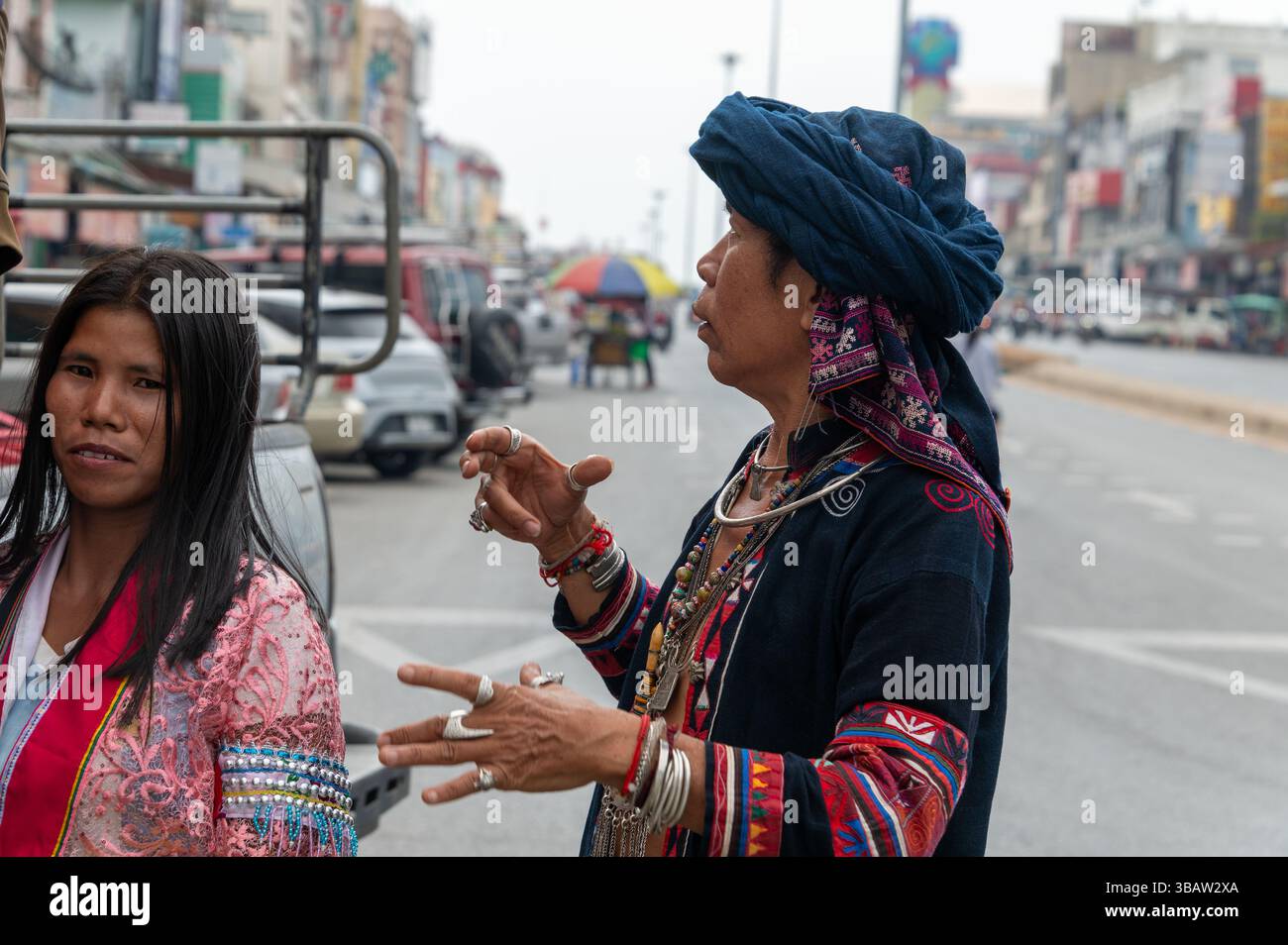 The man appears to be in charge of the arriving  Burmese women as their open open truck arrive in Mae Sai in northern Thailand from Myanmar.  The wome Stock Photo