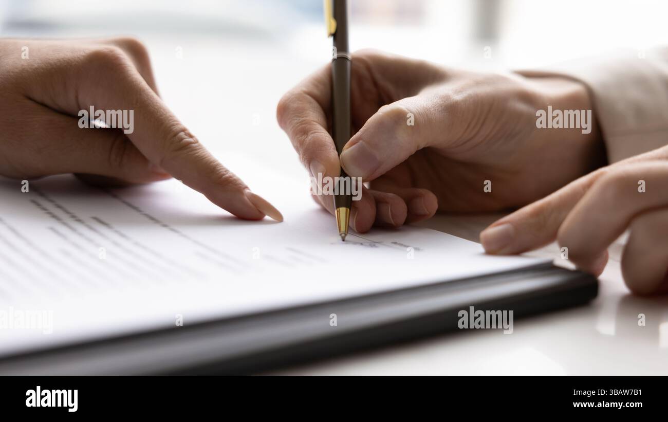 Closeup lawyer hand show client place to sign on contract Stock Photo