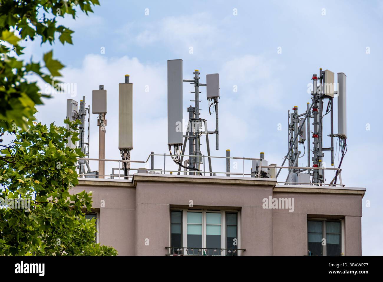 4G and 5G antennas belonging to a telecommunications operator on the roof of a residential building. Concept of mobile phone network coverage Stock Photo