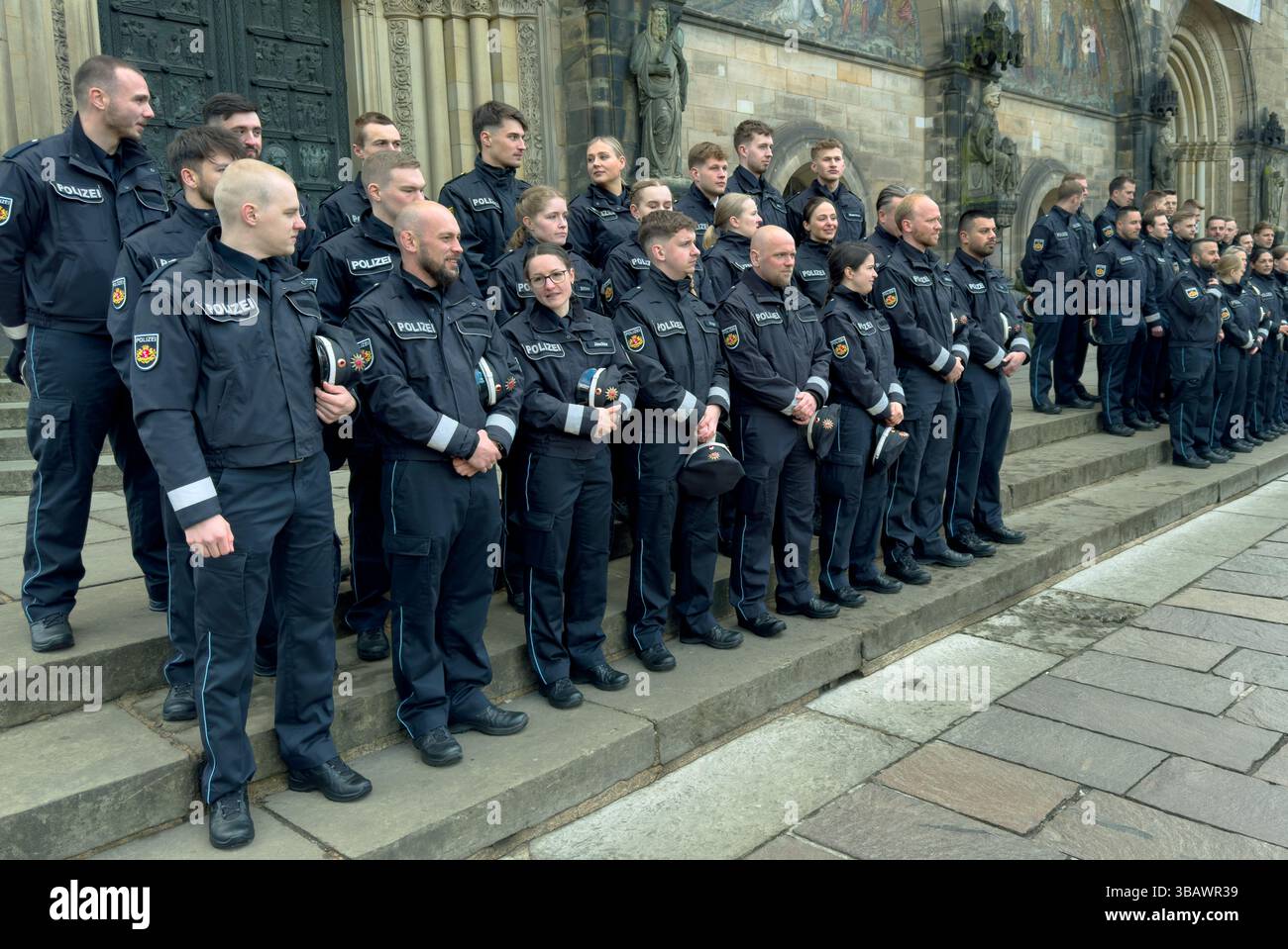 31.03.2025, Germany, Bremen, Bremen - Commissioner-appointees for the Bremen police on the cathedral steps, before their swearing-in ceremony. 00A2503 Stock Photo