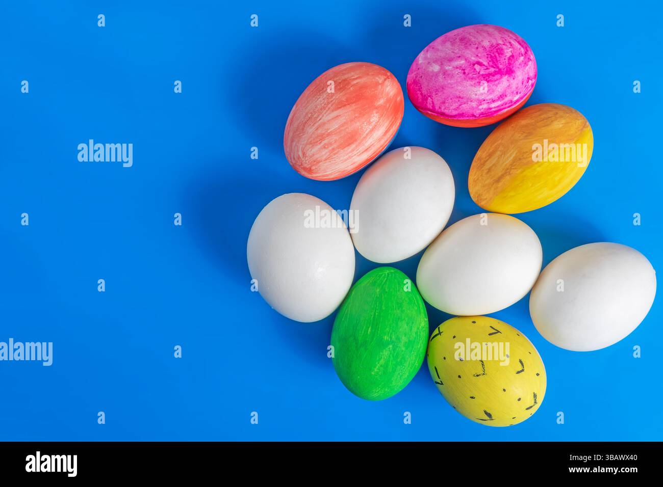 Easter eggs are creatively displayed on a blue background. Perfect for themes of celebration, spring, and cultural heritage. Stock Photo