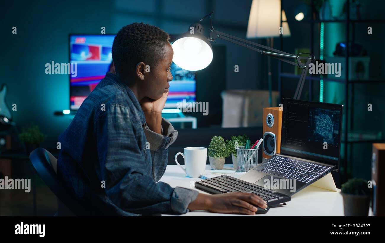 AI expert writes code on laptop in apartment office using Java programming languages. Artificial intelligence programmer remotely working on fixing database errors while working from home, camera A Stock Photo