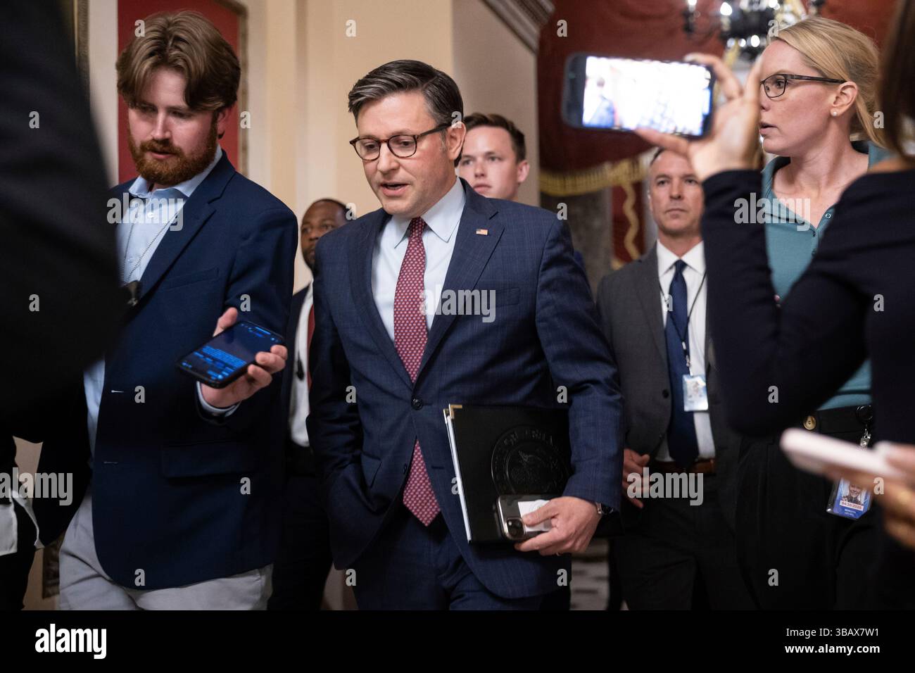 House Speaker Mike Johnson (R-La.) speaks with reporters as he walks to ...