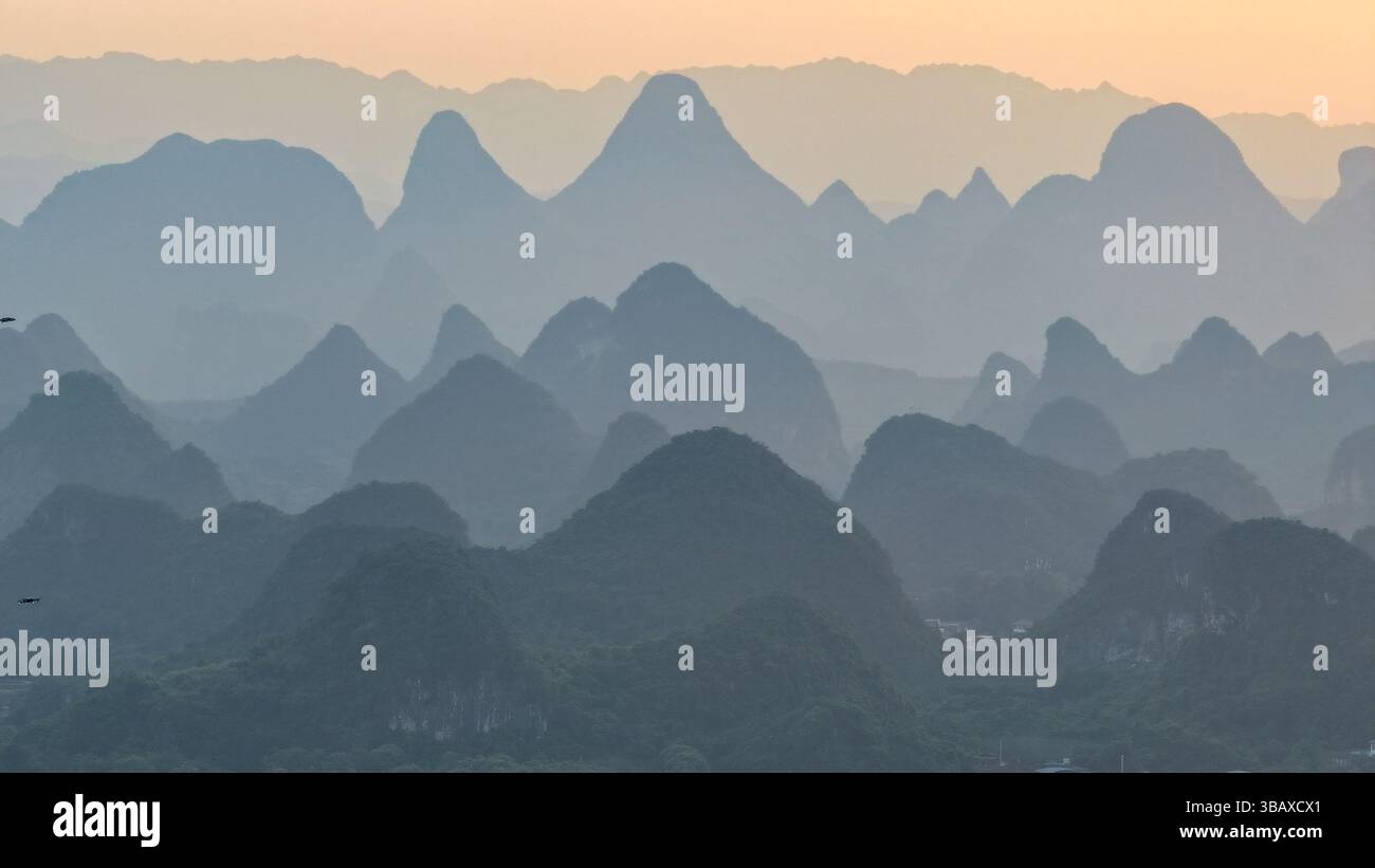YANGSHUO, CHINA - MAY 13, 2025 - The layers of mountains (also known as ...